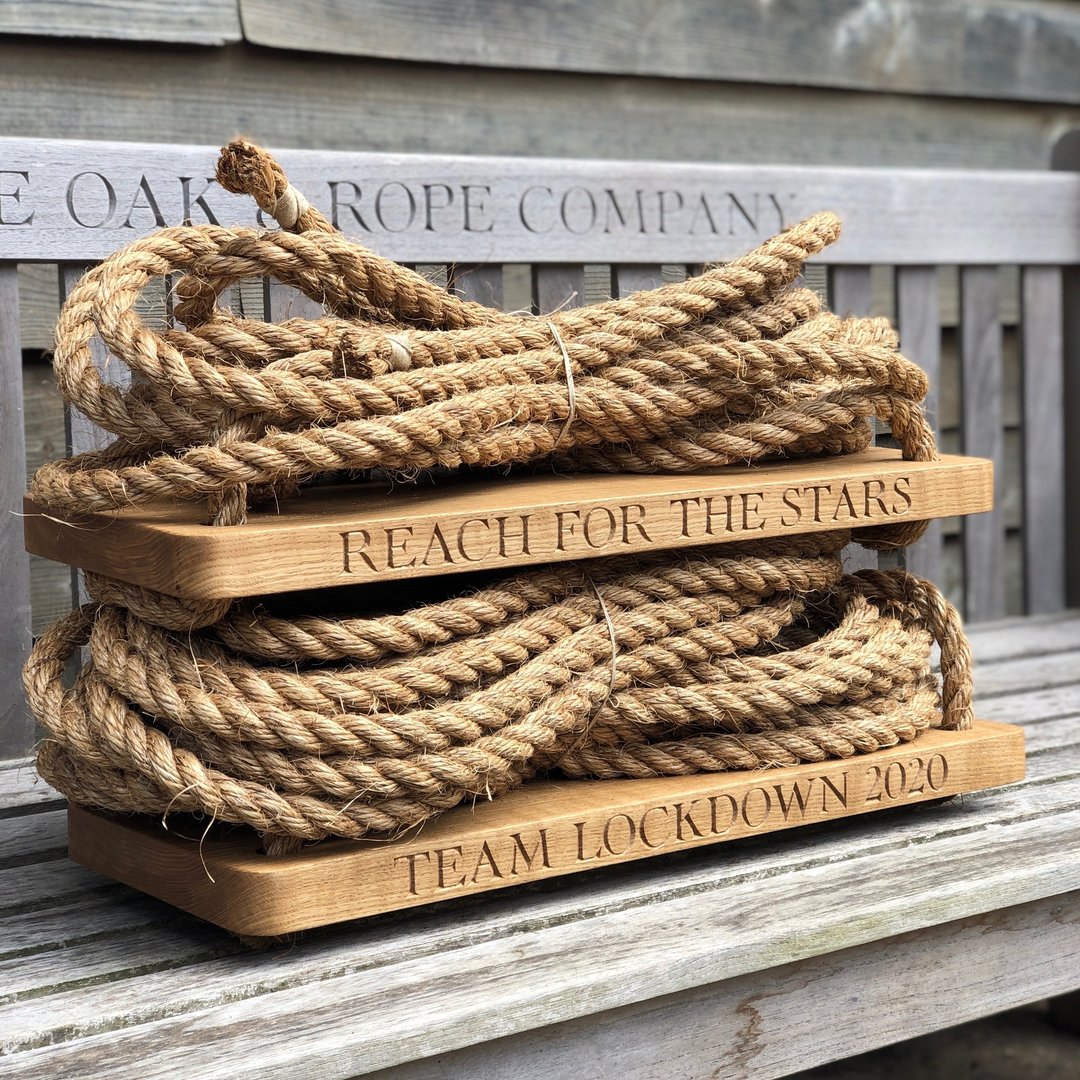 Rope resting on oak swing seat and engraved text on seats
