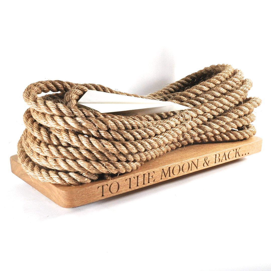 Rope on a n oak swing seat with 'To the Moon & Back' engraving on a white background