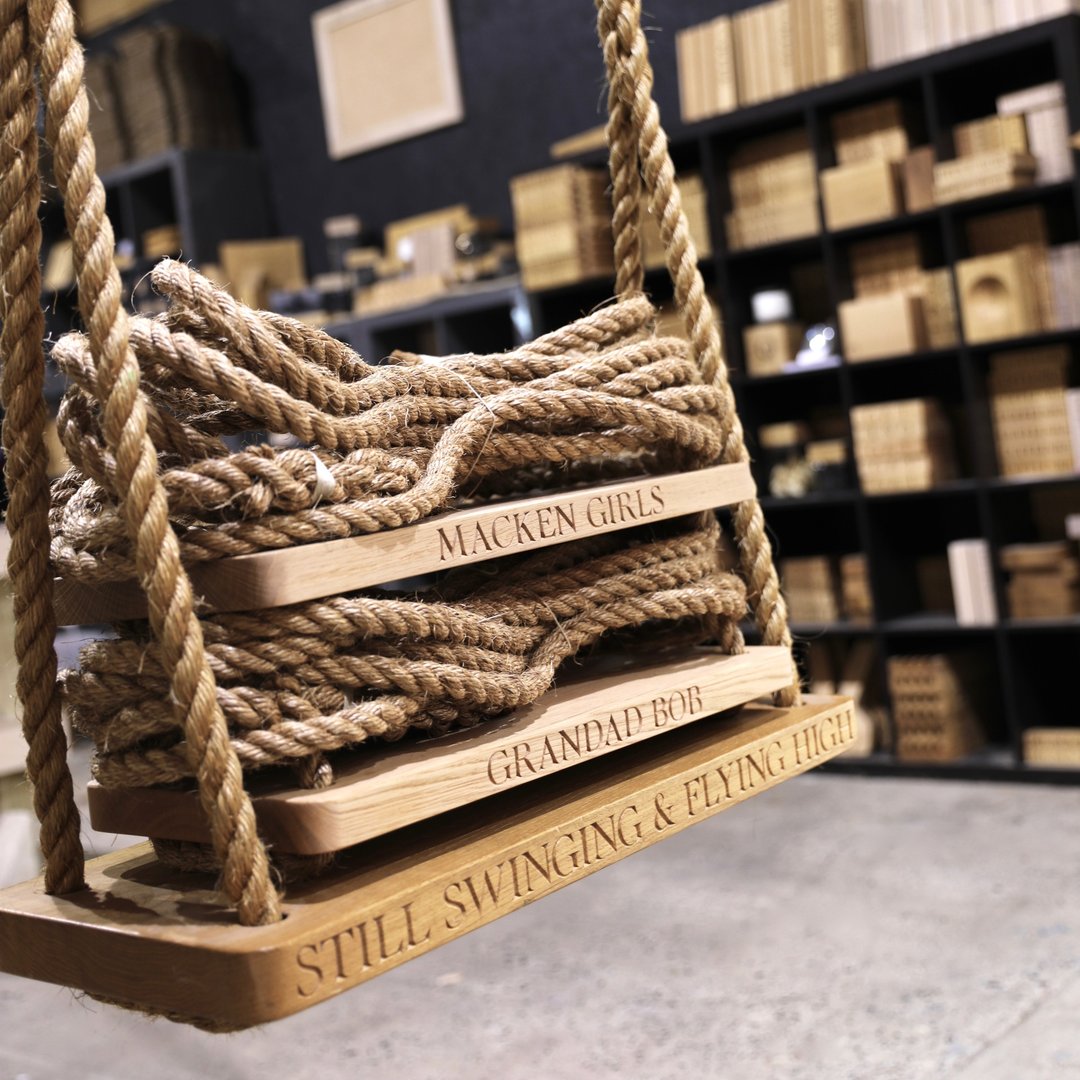 Wooden swing with engraved text in a store setting