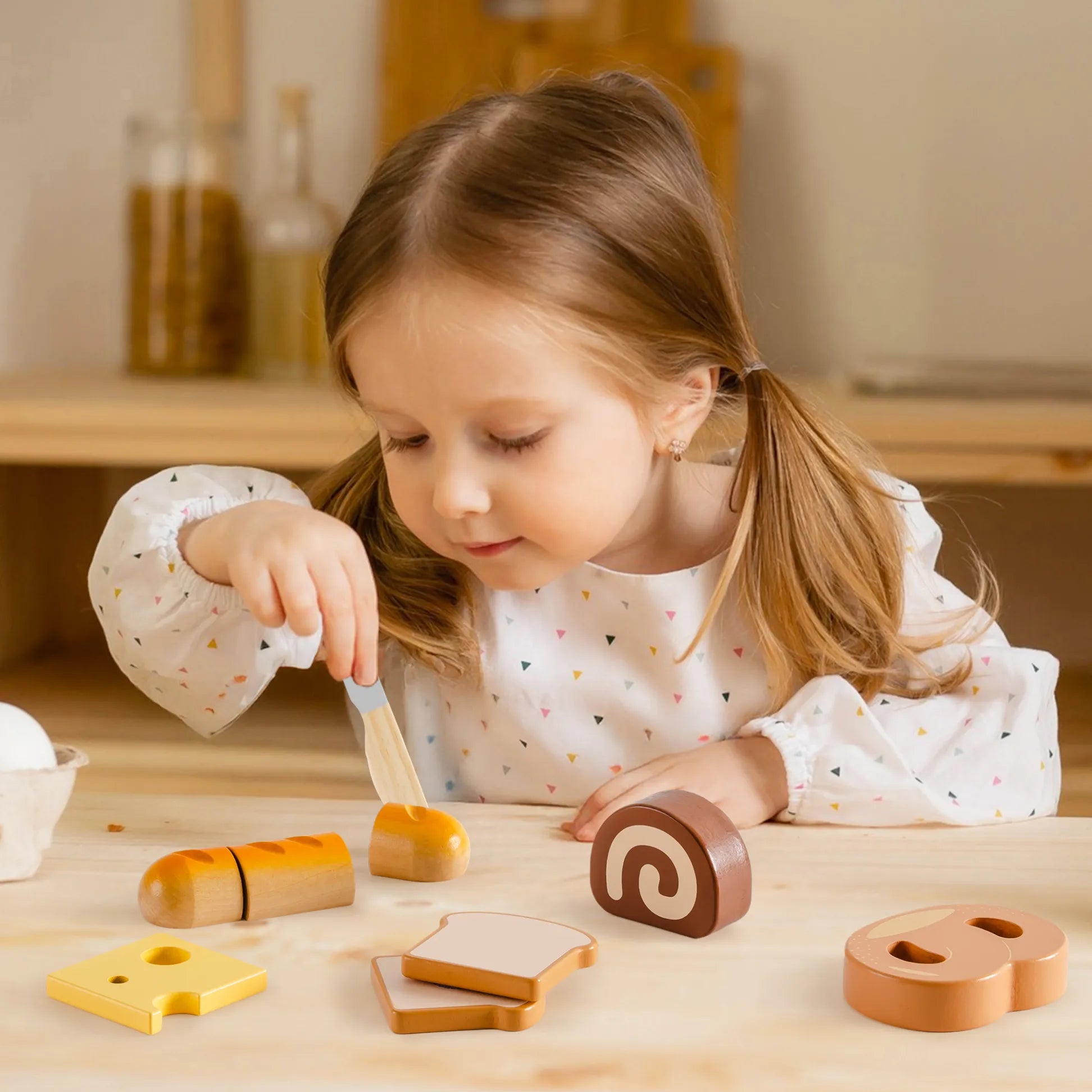 ROBUD Wooden Play Food Set. Includes realistic sliceable desserts, a safe wooden knife. Little girl playing with set.