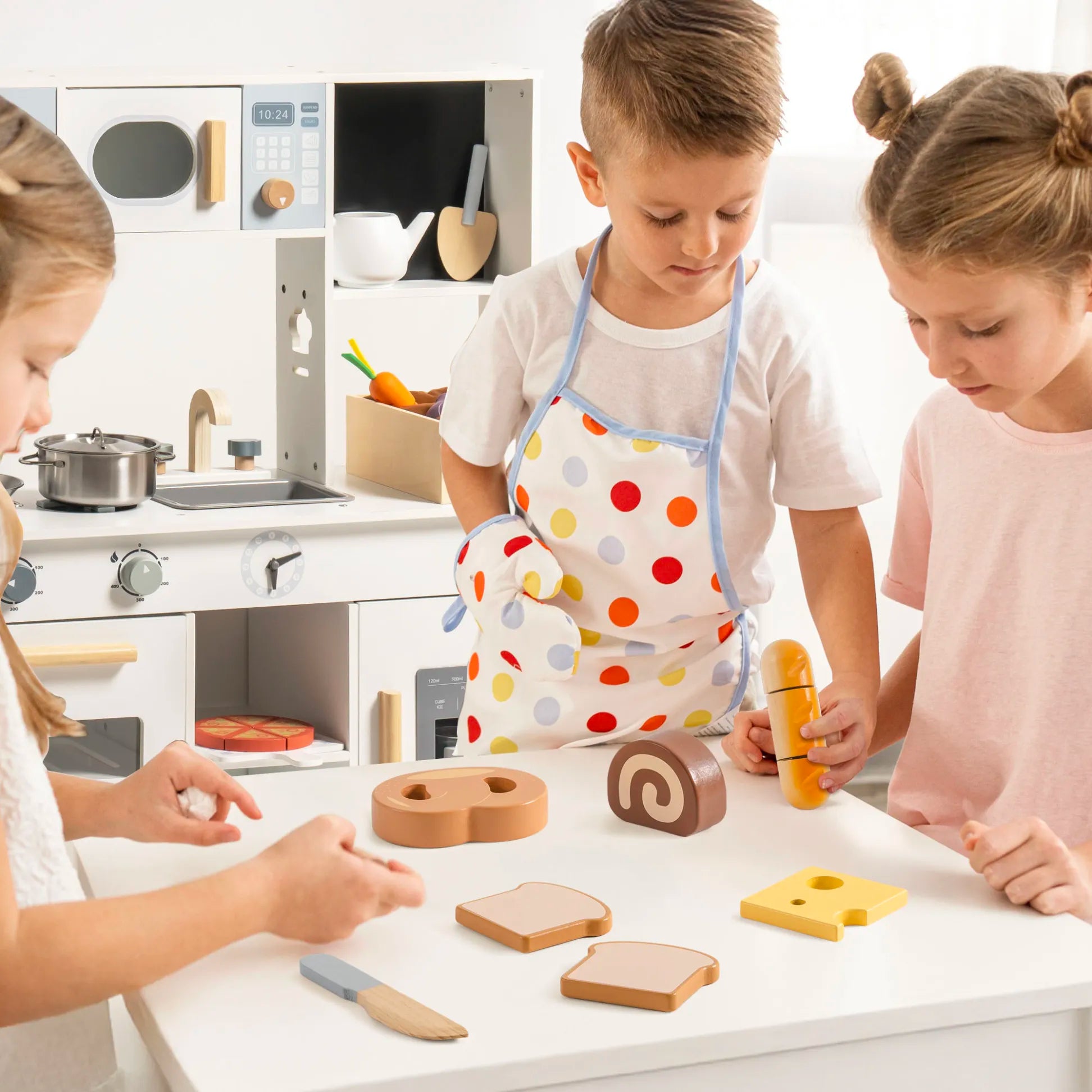Children playing with wooden toys in a kitchen setting