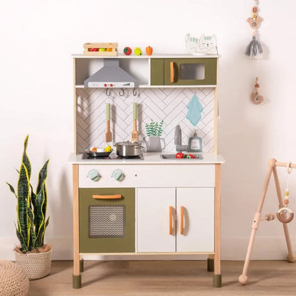 Children's play kitchen set with green and white design in a room setting.