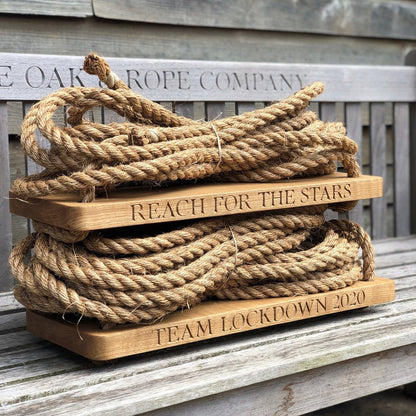 Rope resting on oak swing seat and engraved text on seats
