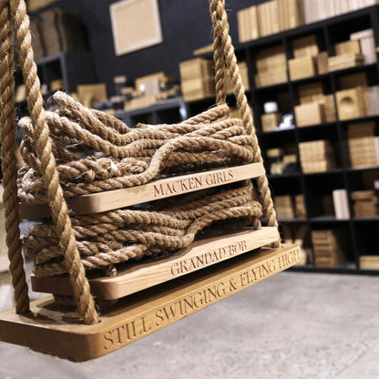 Wooden swing with engraved text in a store setting